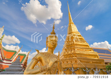 Kinnaree statue at Golden pagoda at Temple of the Emerald Buddha in Bangkok, Thailand. Wat Phra Kaew and Grand palace in old town, urban city. Buddhist temple, Thai architecture. Kinnaree statue at Golden pagoda at Temple of the Emerald Buddha in Bangkok, Thailand. Wat Phra Kaew and Grand palace in old town, urban city. Buddhist temple, Thai architecture. 70931918