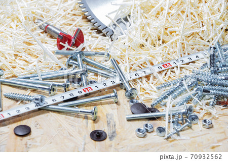 Carpenter tools on wooden table with sawdust. Circular Saw. Carpenter workplace top view. Carpenter tools on wooden table with sawdust. Circular Saw. Carpenter workplace top view. 70932562