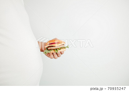 Glutton man eating tasty burger. Fast food Glutton man eating tasty burger. Fast food 70935247