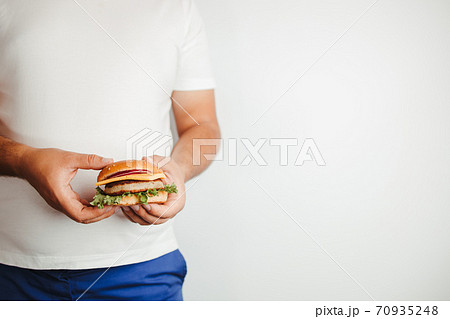 Glutton man eating tasty burger. Fast food Glutton man eating tasty burger. Fast food 70935248