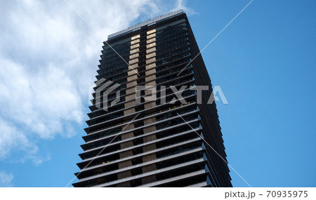 High-rise building against the blue sky and clouds 70935975