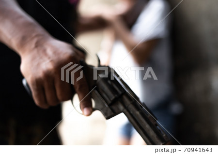 Crime concepts robbery aimed his gun at an asian girl 70941643