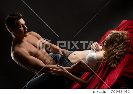 Passionate couple having sex on red sheets Passionate couple having sex on red sheets 70942446