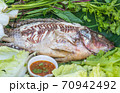 yummy salt-crusted grilled fish in dish 70942492