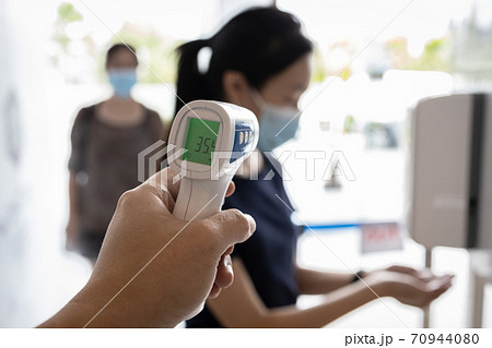 Check body temperature screening using thermometer,prevent people with fever,Coronavirus,cleaning hands with automatic alcohol dispenser,disinfection tunnel,wear face mask at check point for COVID-19 Check body temperature screening using thermometer,prevent people with fever,Coronavirus,cleaning hands with automatic alcohol dispenser,disinfection tunnel,wear face mask at check point for COVID-19 70944080