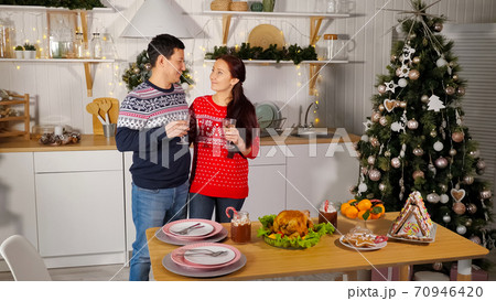 family couple in Christmas style outfit kisses and hugs showing love i family couple in Christmas style outfit kisses and hugs showing love i 70946420