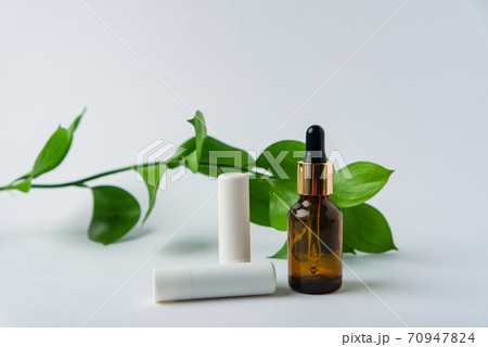 green leaves with tubes on a white background, beauty care green leaves with tubes on a white background, beauty care 70947824