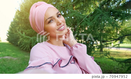 fashionable girl model in purple dressing with hijab poses 70947952