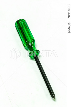 Green handle screwdriver on white background. 70948632