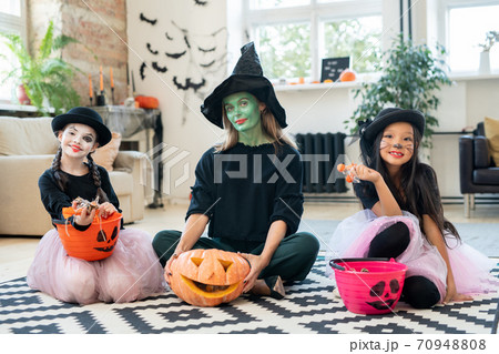 Three pretty witches at Halloween party 70948808