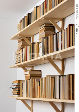 Bookshelves with hardback overturned books Bookshelves with hardback overturned books 70950146