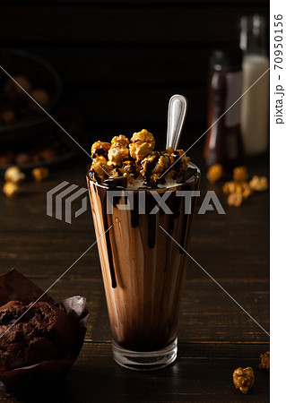 Cup with chocolate milkshake and caramel popcorn 70950156