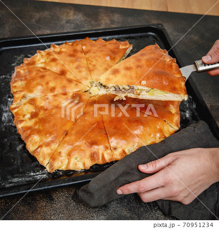Cooked saury fish pie on a baking sheet, top view 70951234