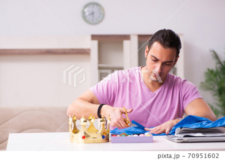 Young male tailor sewing masks at home during pandemic Young male tailor sewing masks at home during pandemic 70951602