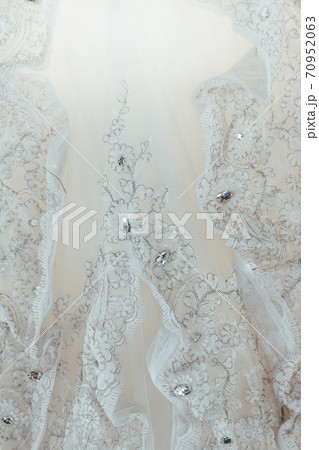 Details of the bride dress fabric and beautiful embroidery wedding concept used as a background for illustrations 70952063