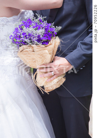 Newlyweds with a bouquet of beautiful flowers 70952226