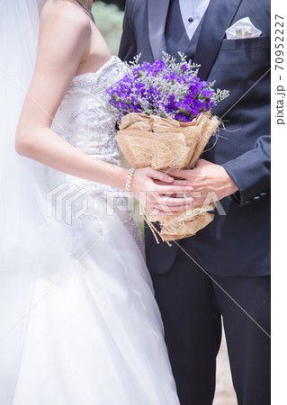 Newlyweds with a bouquet of beautiful flowers 70952227