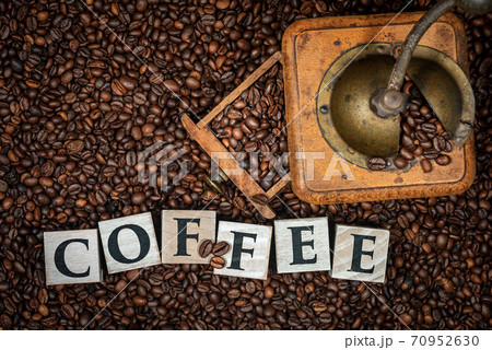 Old Coffee Grinder with Roasted Coffee Beans and Word Coffee 70952630