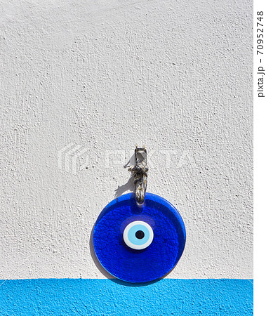 Amulet of evil eye on a wall 70952748