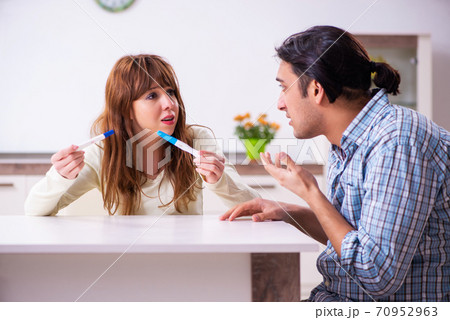 Young couple in unexpected pregnancy concept at home Young couple in unexpected pregnancy concept at home 70952963