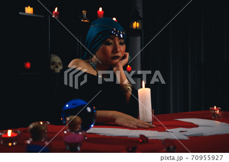 Fortune teller reading tarot card to predict fate or destiny. 70955927