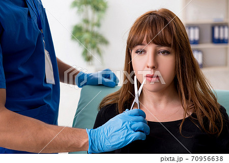 Young beautiful woman visiting doctor in plastic surgery concept Young beautiful woman visiting doctor in plastic surgery concept 70956638