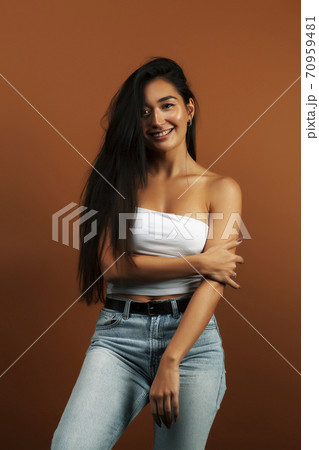 young pretty asian woman cheerful smiling posing on warm brown background, lifestyle people concept 70959481
