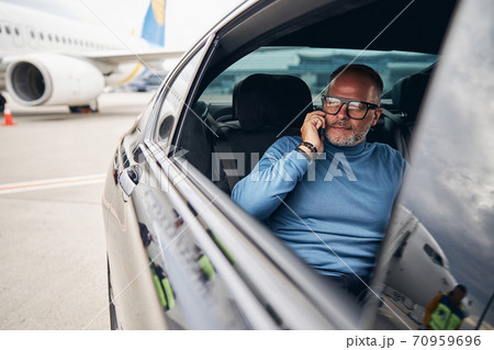 Passenger in a taxi parked at the airdrome Passenger in a taxi parked at the airdrome 70959696
