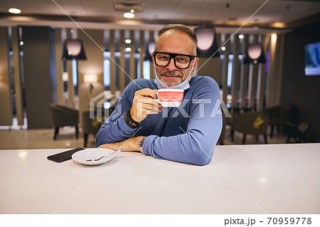 Pleased short-haired Caucasian man enjoying his coffee 70959778