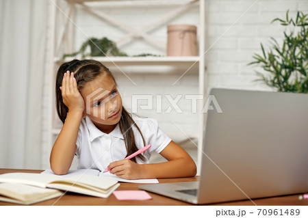 little child girl using laptop for studying online little child girl using laptop for studying online 70961489
