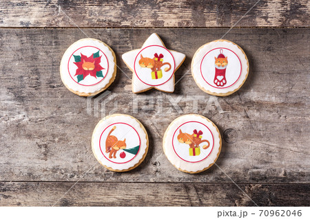 Homemade butter cookies with a printed Christmas cat design on wooden table Homemade butter cookies with a printed Christmas cat design on wooden table 70962046