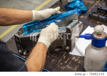 Process of maintenance a parts of a huge mold for plastic moldings, industrial concept Process of maintenance a parts of a huge mold for plastic moldings, industrial concept 70962310