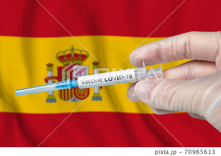 Coronavirus COVID-19 vaccination concept in Spain with doctor hand and syringe Coronavirus COVID-19 vaccination concept in Spain with doctor hand and syringe 70965613