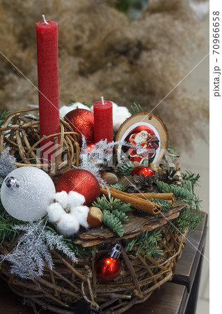 Christmas or New Year composition. Wicker basket with fir branches decorated by natural materials on grey background Christmas or New Year composition. Wicker basket with fir branches decorated by natural materials on grey background 70966658