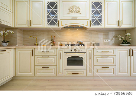 Beige furniture at kitchen in provence style, front view 70966936
