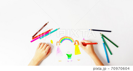 Child drawing his LGBT family. Top view. Child drawing his LGBT family. Top view. 70970604
