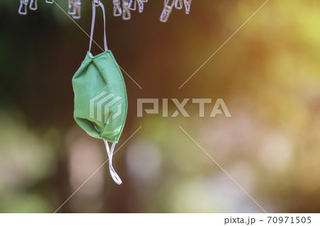 Drying mask hanging under the sun after use for disinfecting. Drying mask hanging under the sun after use for disinfecting. 70971505