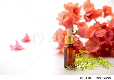 Essential oils bottle with flower background for spa aromatherapy. 70973890