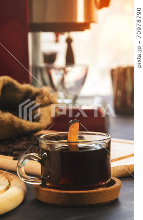 Cup of coffee with cinnamon stick. 70978790