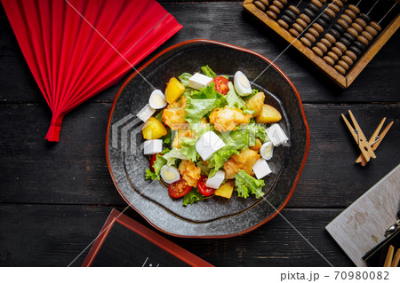 Greek salad with fried fish and cheese 70980082