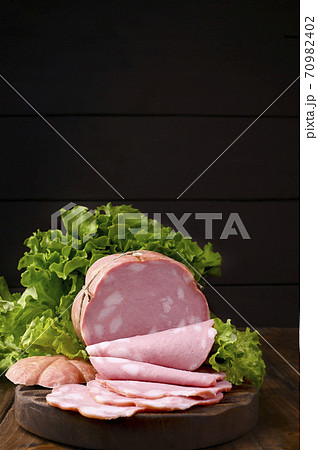 Traditional Italian antipasti mortadella on a wooden plate Traditional Italian antipasti mortadella on a wooden plate 70982402