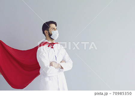 Confident doctor in mask and superhero cape 70985350