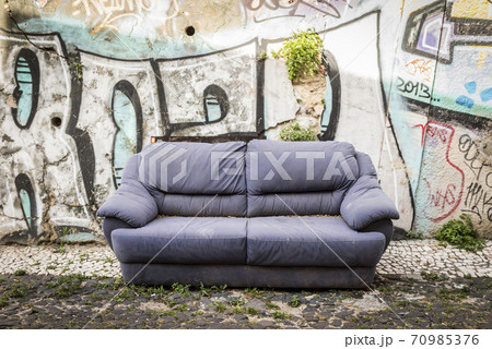 Old discarded sofa on a waste ground in Lisboa, Portugal Old discarded sofa on a waste ground in Lisboa, Portugal 70985376