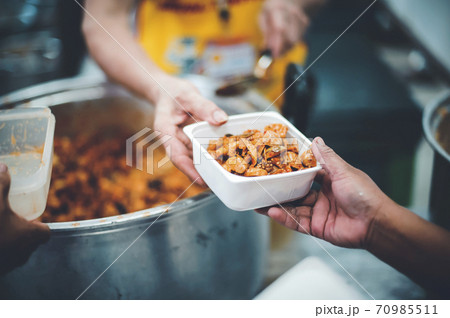 Helping with food donation to the poor 70985511