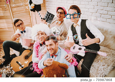 Gay man with guitar shows super gesture.  70987868