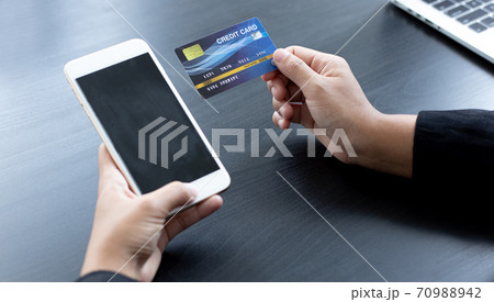 women use smart phone to register online purchases using credit card payments, Convenience in the world of technology and the internet, Shopping online and banking online concept. women use smart phone to register online purchases using credit card payments, Convenience in the world of technology and the internet, Shopping online and banking online concept. 70988942