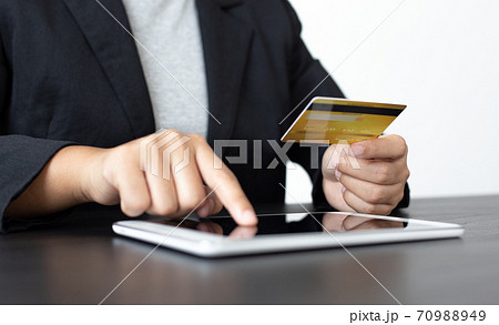 women use laptop to register online purchases using credit card payments, Convenience in the world of technology and the internet, Shopping online and banking online concept. 70988949