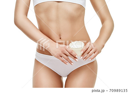 Beautiful Young Woman holding can of cream isolated on white background - Youth and Skin Care Concept 70989135
