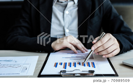 Accounting businessmen are calculating income-expenditure and analyzing real estate investment data, Dedicated to the progress and growth of the company, Financial and tax systems concept. 70989509