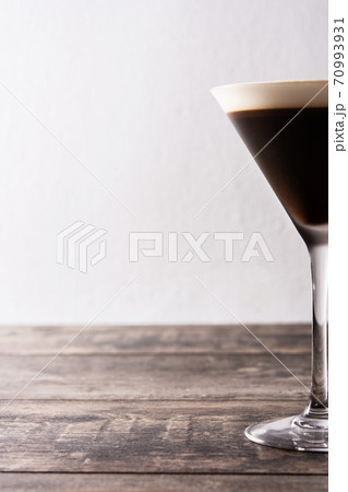 Martini espresso cocktail in glass on wooden table.Copy space Martini espresso cocktail in glass on wooden table.Copy space 70993931